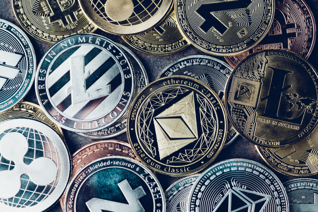 Crypto-currency-background-with-various-of-shiny-silver-and-golden-physical-cryptocurrencies-symbol-coins-Bitcoin-Ethereum-Litecoin-zcash-ripple