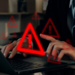 Businessman-using-computer-laptop-with-warning-sign-Notification-error-and-virus-detection-spyware-Internet-network-security-concept-Computer-related-crime-act