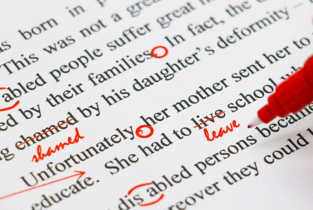 closeup-red-marks-on-proofreading-english-document