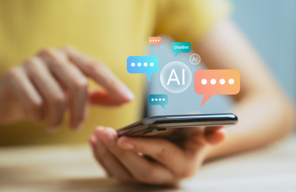 Hand-using-smartphone-and-chatting-with-chatbot-application-shows-message-speech-bubbles-digital-screen-of-social-media-notifications-Ai-Artificial-Intelligence-technology-concept