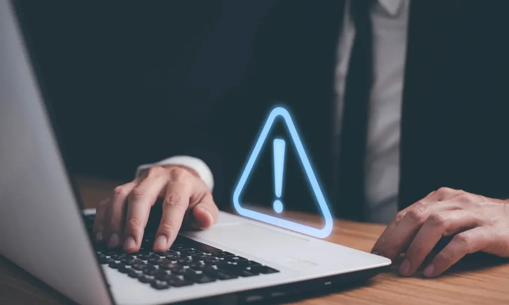Man-using-computer-laptop-with-triangle-caution-warning-sign-for-notification-error-Computer-virus-detected-personal-data-protection-network-security-and-maintenance-concept
