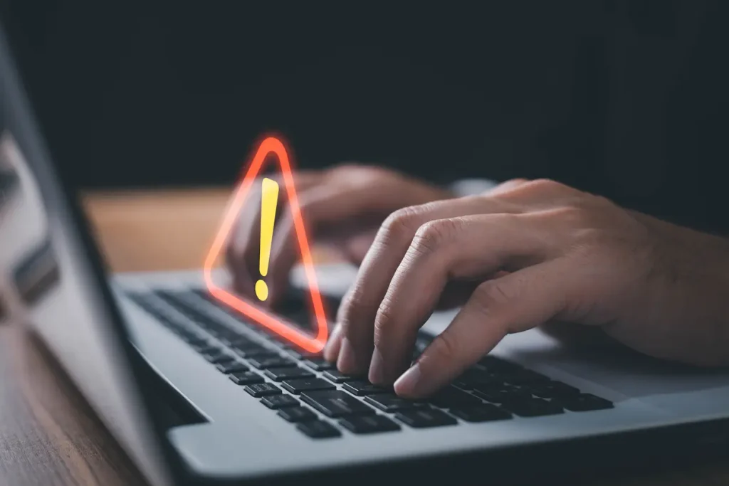 It-staff-programmer-developer-using-computer-laptop-with-triangle-caution-warning-sign-for-notification-error-and-maintenance-concept