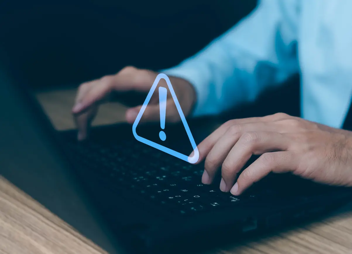 Businessman-using-computer-laptop-with-triangle-caution-warning-sing-for-notification-error-and-maintenance-concept