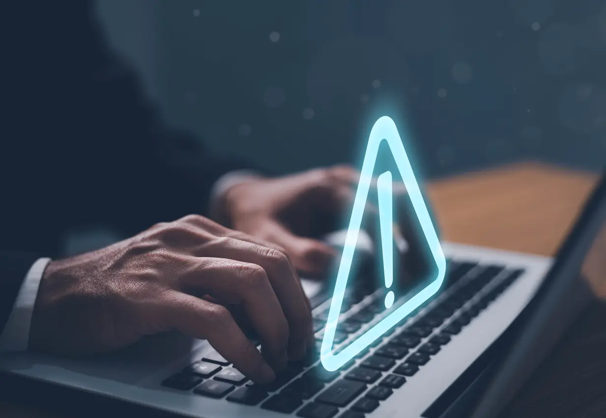 Error-and-maintenance-alert-Businessman-using-computer-laptop-with-triangle-caution-warning-sing-for-notification-error-and-maintenance-concept